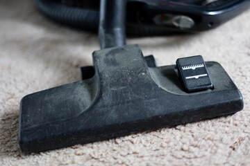 Close Up Of A Dusty Black Plastic Vacuum Cleaner Brush Head With Mode Switch, Resting On A Beige Carpet.