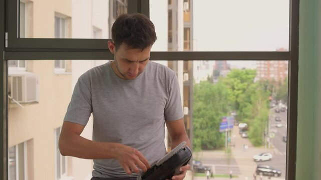 A man uses an automatic window cleaner for sparkling, crystal-clear glass and a spotless finish