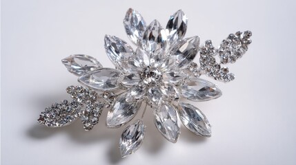 Fototapeta premium Elegant floral brooch with crystal petals placed on a smooth white background