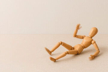Falling wooden mannequin in dynamic motion. Space for text.