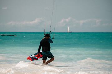 Kite surfing on blue water, kitesurfer with a board and harness, water sports scene