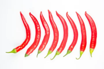 Gardinen Red hot chili peppers on a white background. Vitamin vegetable food © photosaint