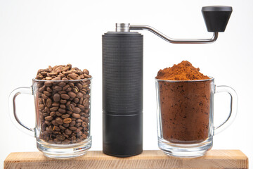Two glass mugs, one filled with coffee beans and the other with ground coffee, flank a sleek manual...