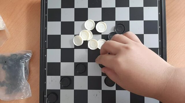 playing the checkers board game
