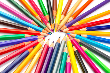 A dynamic array of multicolored pencils radiating outward on a white background, creating a...