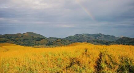 Scenic view of panoramic mountain landscapes against a rainbow background at Chyulu Hills National Park in Kenya 