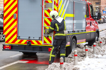firefighter man works on his fire truck. fire safety service