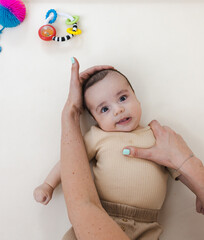 Torticollis in infants. Physiotherapist performs examination to diagnose wryneck in child, performs...
