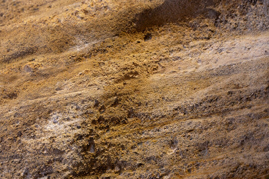 Texture or background of a stone tuff wall in brown colors