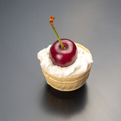 fresh cherry berries in milk cream lie in a waffle basket. healthy food for breakfast. fruits of...