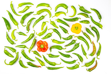 green hot peppers and red and yellow bell peppers on a white background. vitamin vegetables for...