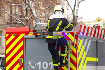 firefighter man works on his fire truck. fire safety service