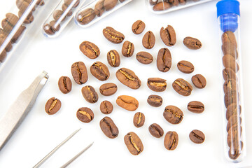 Caffeine Research and Laboratory Experiment – A scientific study concept with coffee beans in test tubes, tweezers, and a magnifying glass, focusing on coffee evaluation