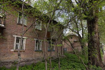 Old brick apartment building in spring