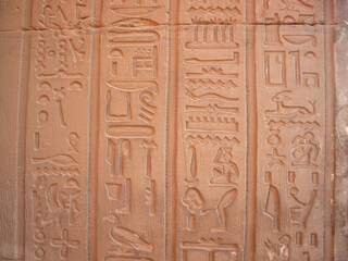 Ancient egyptian hieroglyphs carved on the walls of Kom Ombo temple in Aswan, Egypt