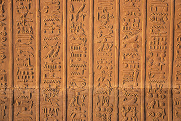 Ancient egyptian hieroglyphs carved on the walls of Kom Ombo temple in Aswan, Egypt