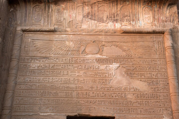 Ancient egyptian hieroglyphs carved on the walls of Kom Ombo temple in Aswan, Egypt
