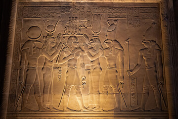 Ancient egyptian carvings on the walls of Kom Ombo temple in Aswan, Egypt