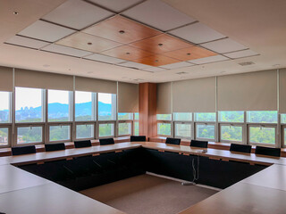 Interior of a university lecture room with neatly arranged desks and chairs for learning.