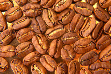 Detailed shot of roasted coffee beans with natural splits, arranged on a golden tray, great for coffee packaging designs.
