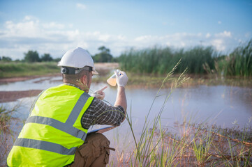 An environmental expert is collecting water samples from a natural pond to test the ecosystem for...