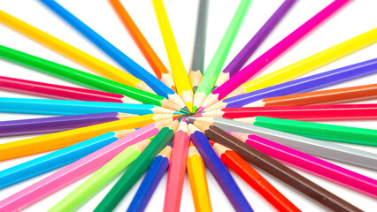 A vibrant burst of colored pencils arranged in a radial pattern against a white background,...