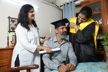 Indian Happy graduate student and proud parents celebrating graduation degree convocation ceremony...