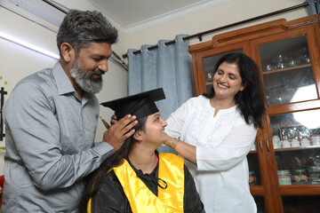 Indian Happy graduate student and proud parents celebrating graduation degree convocation ceremony...