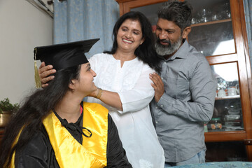 Indian Happy graduate student and proud parents celebrating graduation degree convocation ceremony...