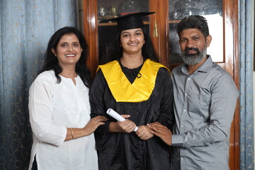 Indian Happy graduate student and proud parents celebrating graduation degree convocation ceremony...