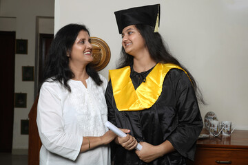 Indian Happy female graduation student with her mother. celebration and achievement. Family,...