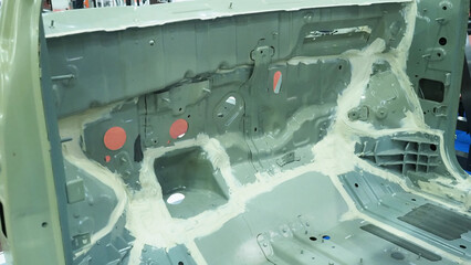 Car body.The interior of a vehicle chassis undergoing seam sealing
