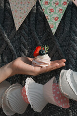 Woman holding a cake decorated with fresh berries