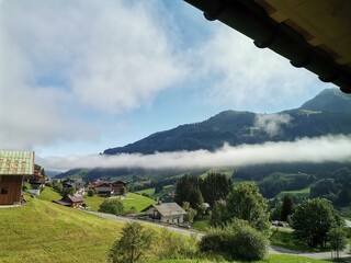 A collection of atmospheric mountain landscapes featuring dramatic cloud formations, drifting fog,...