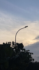 Silhouette street lamp at sunset peaceful twilight sky background