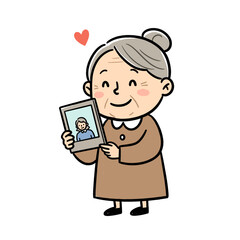 Elderly woman smiling while holding a photo of family with love  
