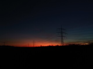 Vivid sunset with warm hues of orange and red fading into soft purples, casting reflections over a...