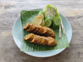 Sliced ​​pork roll placed on a plate with cucumber.