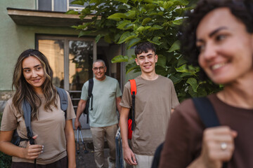 caucasian family with backpacks prepare to go, concept of family trip