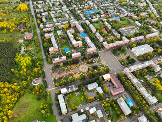 An aerial view of a symmetrical residential square in Ridder, Kazakhstan, surrounded by apartment...