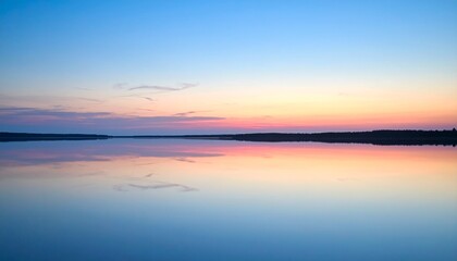 Fototapeta premium Abstract twilight gradient washes across a clean sky, reflected faintly on a still water surface with no distractions. 