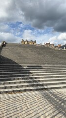 Large Stone Staircase Leading to Building Under Cloudy Sky