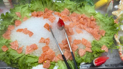 Raw Salmon Chunks on Ice Display with Lettuce and Accessories