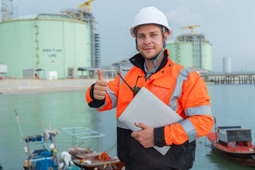 Engineer at LNG Facility Holding Laptop