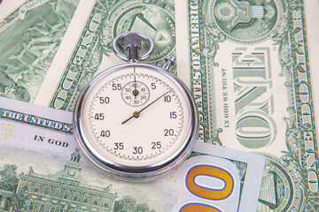 mechanical stopwatch on the background of dollars. Part time accuracy for business. business and...