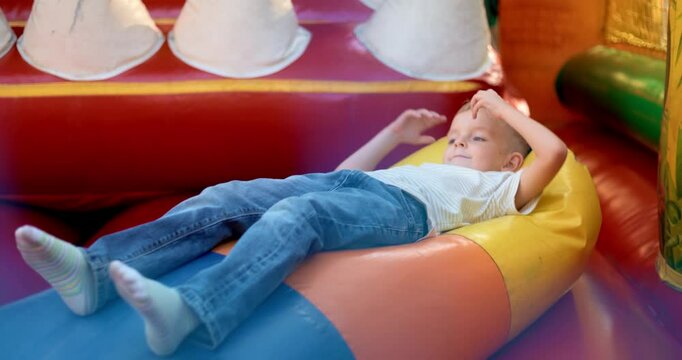 Child Playing in Colorful Inflatable Bounce House
