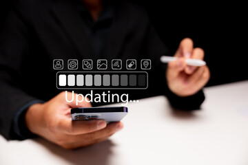 A person holds a smartphone while interacting with a digital interface showing an updating progress...
