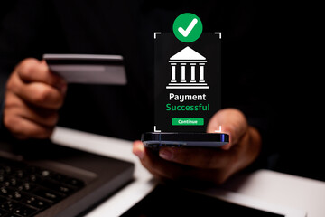 A person holds a credit card and smartphone showing a 