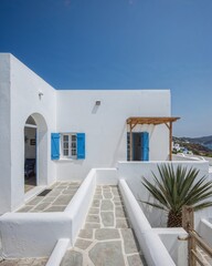 Back view of a Greek island style house that fuses ancient architecture with minimalism designed in a white and azure blue theme