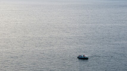 Panoramic view of Lake Toba with the ferry sailing with tourists. Beautiful nature with views of...